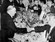 Rt. Hon. W.L. Mackenzie King shaking hands with guests at a celebration of his twentieth anniversary as Leader of the Liberal Party 8 Aug. 1939
