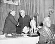 Rt. Hon. W.L. Mackenzie King shaking hands with Hon. J.L. Ralston at a banquet celebrating King's twenty-fifth anniversary as Leader of the Liberal Party 7 Aug. 1944