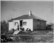 Masao Tsutsumi and wife, and their son Yoshinori and his wife and three children, live in this cottage on the banks of the Red River at Parkdale [Manitoba]