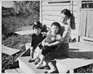 Mrs. Yoshinori Tsutsumi and her two children Mitsuo and Kazuko