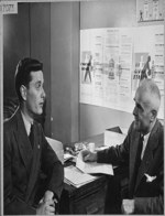 An official of the Department of Veterans' Affairs interviewing Mr. Jack Bryson (left) at the time of his discharge from the R.C.A.F Sept. 1945