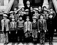 [Children of the Ottawa Jewish community on steps of the Old Talmud Torah Hall, George St., Ottawa, Ontario.] [c 1930]