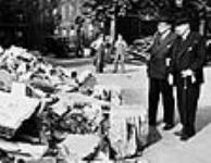 Rt. Hon. W.L. Mackenzie King and Hon. Herbert Morrison examining bomb damage at the Temple Library 4 Sept. 1941