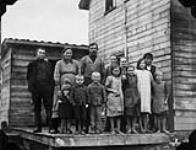 Adolph Miesner, German Baptist from Poland settled near Minitonas, Manitoba. This photo shows the Miesner family at their home with some friends Aug., 1927
