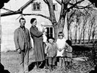 The Kunc family (recent Polish immigrants) in front of their farm house near Winnipeg, MB. 1930 1930