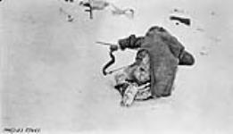 Kesullik shooting his bow, Bernard Harbour, [N.W.T.], April 1916 April 1916