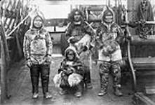 Four unidentified Inuit on board a ship, June 1889 June 1889.