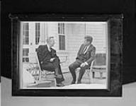 Lester B. Pearson, Prime Minister of Canada, with John F. Kennedy, President of the United States of America, sitting on porch at the Kennedy compound May 1963.