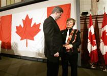 [Prime Minister Stephen Harper poses with Elisabeth Hoffman-Lamoureux Flag Day Ceremony, Ottawa] 15 February 2006