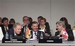 [Prime Minister Stephen Harper chats with Quebec Premier Jean Charest and New Brunswick Deputy Premier Paul Robichaud during a plenary session at the Francophonie Summit in Montreux, Switzerland] 24 October 2010