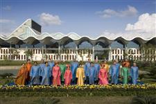 [Leaders attending the Asia-Pacific Economic Cooperation (APEC) summit pose for a family photo wearing traditional Vietnamese clothes, known as the 'ao dai,' outside the National Convention Centre in Hanoi, Vietnam] 19 November 2006