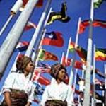 Two young women in front of flags at Place des Nations, Expo 67, on opening day Apri1 27, 1967.