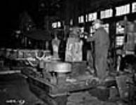 Workmen forge part of a Corvette ship in a Canadian shipbuilding yard mai 1940