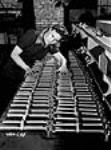 Dorothy Stuart making final inspection of Bren gun Flare guards at John Inglis Co. plant Apr. 1941