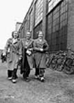 Three woman employees arrive for work at the John Inglis plant mai 1941