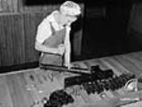 Viola Davies assembling 2" trench mortar, Elevator Company, Toronto, Ontario jui1. 1941
