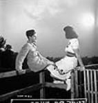 Female Dominion Arsenals Ltd. munitions worker and her boyfriend enjoy the August moon 24 Aug. 1942