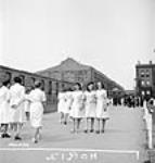 Women munitions workers enjoy a walk after lunch at the Dominion Arsenals Ltd. plant 24 Aug. 1942
