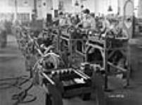 Workmen manufacture machine tools in a Toronto plant 28 Sep. 1942