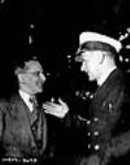 Hector Duchesneau, foreman smithy with Davies since 1886 speaks with Captain P.D. Townsend, skipper of the S.S. Fort Albany at the S.S. Fort Albany's launch ceremony May 1943
