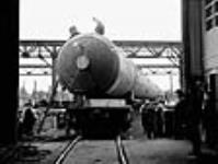 Huge tank on a railway car being hauled from Montreal, Quebec to Sarnia, Ontario to be used in a synthetic rubber plant June 1943