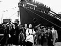 Priest and guests of honour pose in front of the "Kirkland Lake" during its launch ceremony May 1944