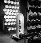 Painted torpedo head dries under infra-red lights in the John Inglis Co. plant May 1944