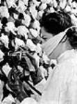 Female worker inoculating broth in surface culture bottles with penicillin spore force-sprayed in by sterile air in the Merck labs mai 1944