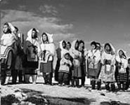 Inuit women in new parkas await the arrival of passengers from R.M.S. Nascopie August 1946