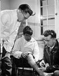 Drs. Gordon Gaulton (right) and Jim Osborne (left) discussing an Inuit patient's condition August 1946