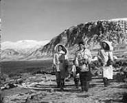 Three Inuit women walking along the shore August 1946
