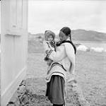 Hahudluk with her baby on the way to church in Cape Dorset, N.W.T August 1961.