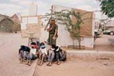 Canadian Airborne Regiment, Chaplain Capt. Mark Sargent Behind a Group of Bound and blindfolded Somali Civilians 1990s