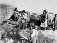 Inuit women and children landing on coast 1929