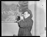 Profile view of photographer Michael "Miki" Berens at the Standish Hotel [ca. 1950]