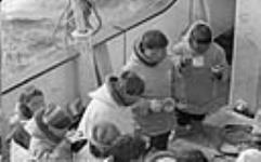 Group of Inuit drinking coffee aboard R.M.S. Nascopie ca. 1945-1946