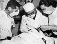 [An eye operation is performed in hospital of the C.G.S. C.D. Howe, Eastern Arctic patrol vessel, on Nootaragyook, an Eskimo of Pond Inlet, N.W.T.] July 1951