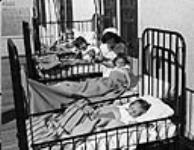 A nurse is with young polio patients at the University Hospital in Edmonton, AB Sept. 1947