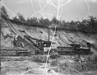 Quebec, Montreal, Ottawa & Occidental Ry. 18 ST. JEAN BAPTISTE with QM020 Flat Car 21 at ballast pit c. 1880