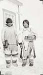 Unidentified Inuit man and woman standing in front of a building [graphic material] 1936
