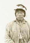 Portrait of an unidentified Inuk man wearing a captain-style hat with a white cloth tied around it [graphic material] 1926