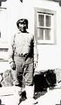 Inuk man, in a knitted hat, posing in front of a building [graphic material] 1936