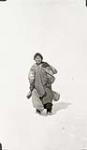 Unidentified Inuk woman trekking through the snow [graphic material] 1936