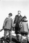 Gavin White and two unidentified Inuit boys carrying Cooey rifles [graphic material] 1950