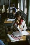 Two girls working at their desks mai 1965.