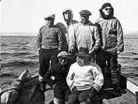 Unidentified Inuit on a boat with J.W. Anderson and W. Heslop [graphic material] Cape Smith, N.W.T., [Nunavut], 1945 1945.