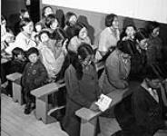 Inuit women attend Mass at Roman Catholic mission in Chesterfield Inlet (Igluligaarjuk) [graphic material] 1946 or 1947.