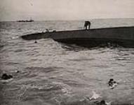 Crew of an Infantry Landing Craft swim for it as their craft keels over 1944.