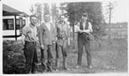 F.O. Wishart, Jack Denoor, Gordon Richardson, and Dr. Bradwin. Hudson Bay Railway. July 1928?.