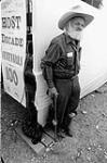 Local man at Discovery Days in Dawson City. His small niece clings to his knees 1996.